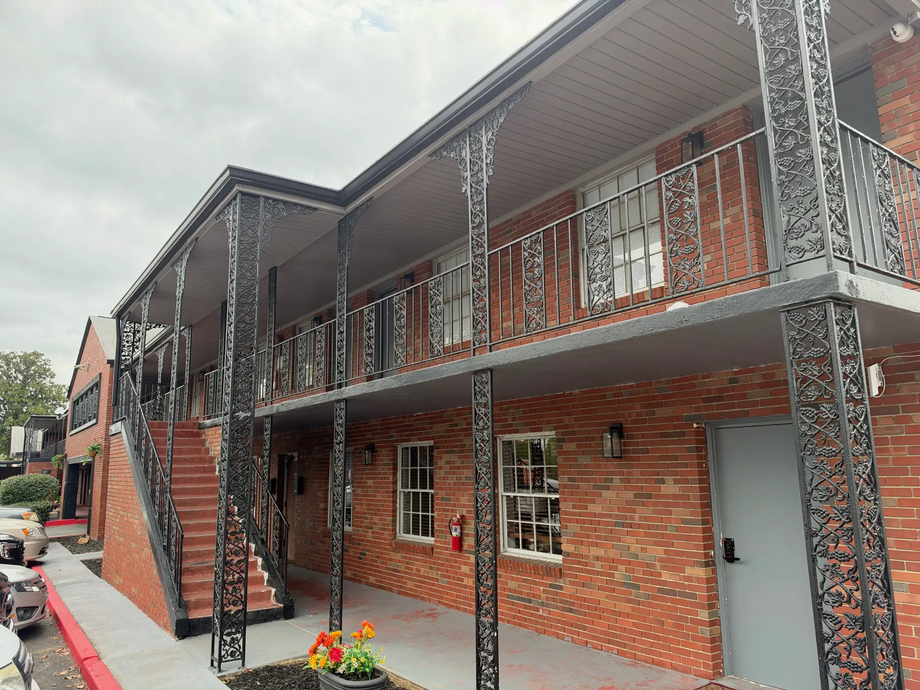 Two-story brick residence building at Magnolia Recovery Community with exterior stairs and walkway