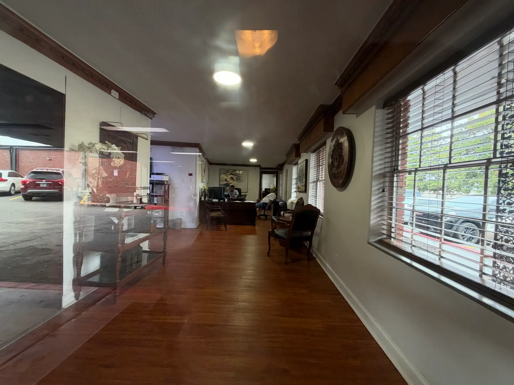 Bright hallway with wood floors and windows